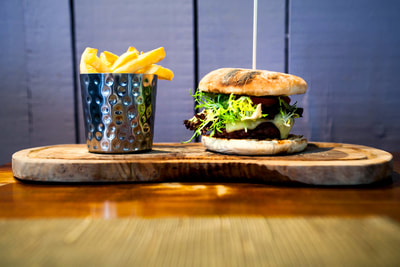 Gourmet burger with chips, wooden board